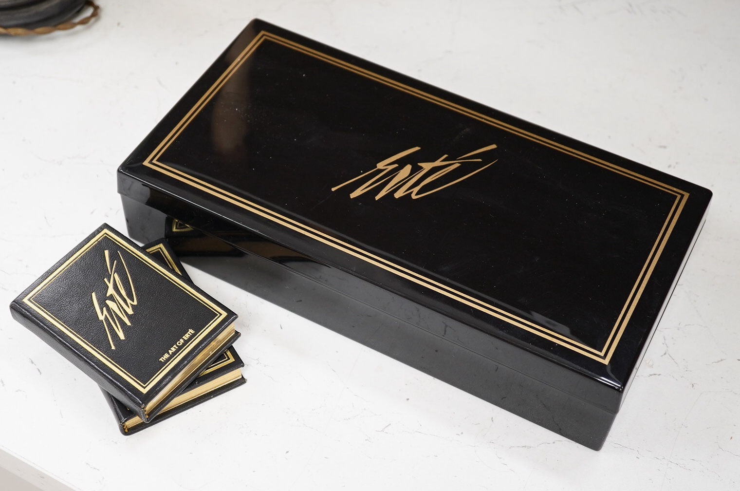 An Erte Bridge card set, boxed and two signed Erte books on his art, bridge box, 28.5cm wide. Condition - good